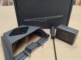 a box with a remote and a mouse on a table