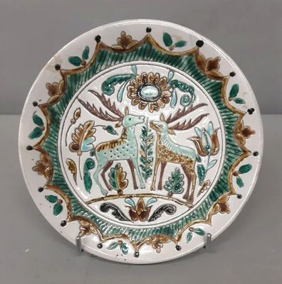 a plate with a picture of a deer and a deer on it