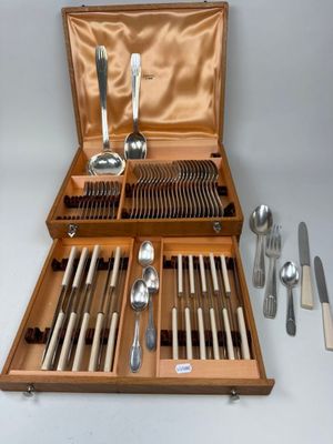 a wooden case with silverware in it on a table
