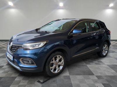 a blue car is parked in a room with a checkered floor