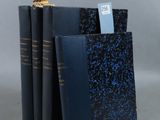 trois livres sont empilés sur une table
