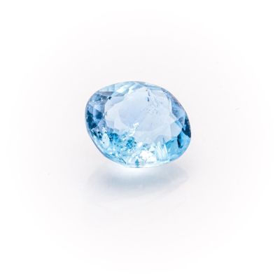 a close up of a blue topazte stone on a white surface