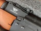 an image of a close up of a rifle on a table