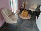 two chairs and a table in the corner of a room