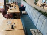 a long wooden table with a blue bench in the middle of the room