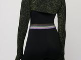 a woman wearing a green leopard print top and black leggings