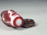 a small red and white object on a white surface
