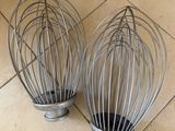 two wire whisks on the floor next to each other