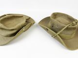 two hats with ties on them are sitting on a white surface