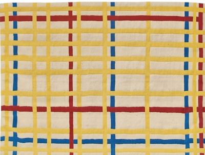 a yellow rug with blue, red and white squares on it