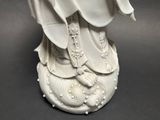 statue of a woman in a white robe holding a white umbrella