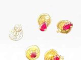 three pairs of gold earrings with pink stones on a white surface