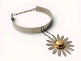 silver and gold flower necklace with a chain on a white background