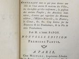 an old book that is open on a table