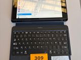 a laptop computer sitting on a table with a price tag on it