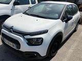 a white car parked next to a white truck in a parking lot