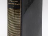 a close up of a book on a white surface with a black cover