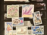 a lot of stamps on display in a glass case