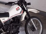 a white and black motorcycle parked in a garage
