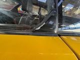 a close up of a yellow taxi cab with a broken windshield