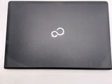 a black laptop with a white logo on the screen