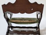 a wooden bench with a green cushion on it
