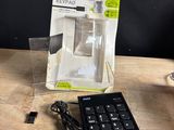 a remote control sitting on a table next to a keyboard