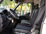 the interior of a white van with black seats and a steering wheel
