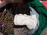 a suitcase filled with clothes and a leopard print blanket