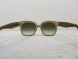 sunglasses on a table with a white table cloth and a white wall