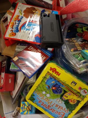 a pile of children ' s toys and books on the floor