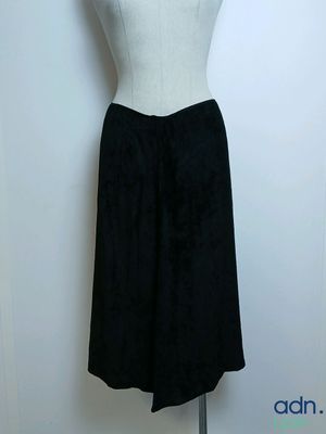 a black and white dress on a mannequin stand