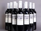 six bottles of wine are lined up in a row on a table