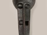 a close up of a metal mask on a wall