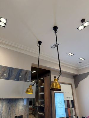three lights that are hanging from the ceiling in this kitchen