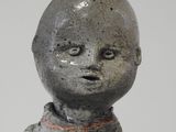 a small statue of a baby sitting on top of a table
