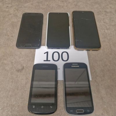 several cell phones are sitting on a table with a price tag