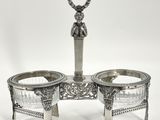a silver plate with two bowls and a spoon on top of it