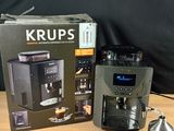 a coffee maker and a grinder sitting on a table