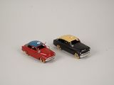 two toy cars that are sitting next to each other