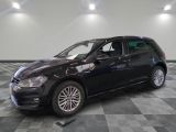 the black volkswagen golf is parked on a checkered tile floor