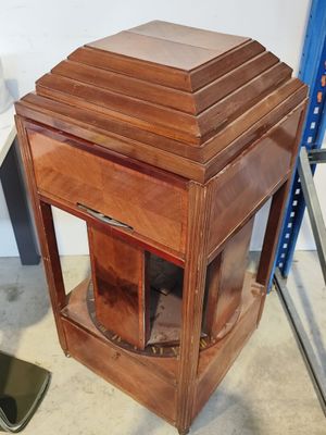 a small wooden table with a glass door on top of it