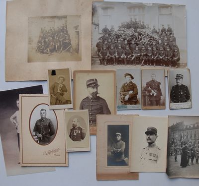 an old photo of a group of men in uniform posing for a picture