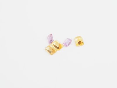gold and amethe earrings on a white background