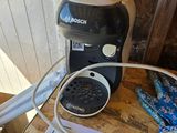 a coffee maker on a table next to a box of ice cream