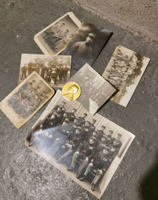 an old photo of a group of people sitting on top of a cement floor