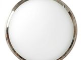 un miroir rond avec un cadre en métal accroché à un mur blanc