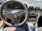 dashboard of a car with a steering wheel and dashboard gauges