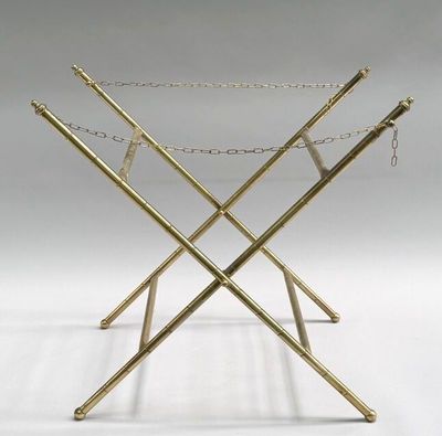 an image of a gold luggage rack with chains hanging from it