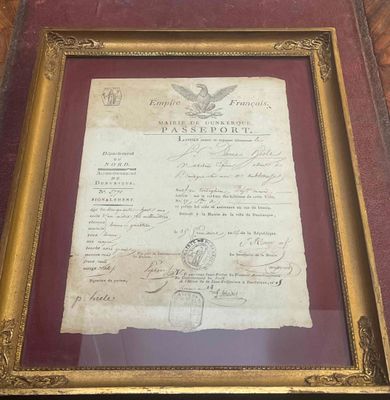 an old document is on display in a frame on a table